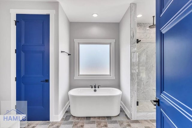 full bath featuring a marble finish shower, baseboards, and a freestanding bath