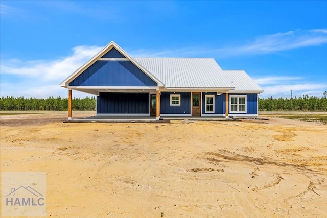 view of front of home with a porch and metal roof