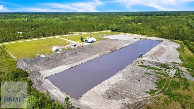 bird's eye view of a heavily wooded area and a large body of water