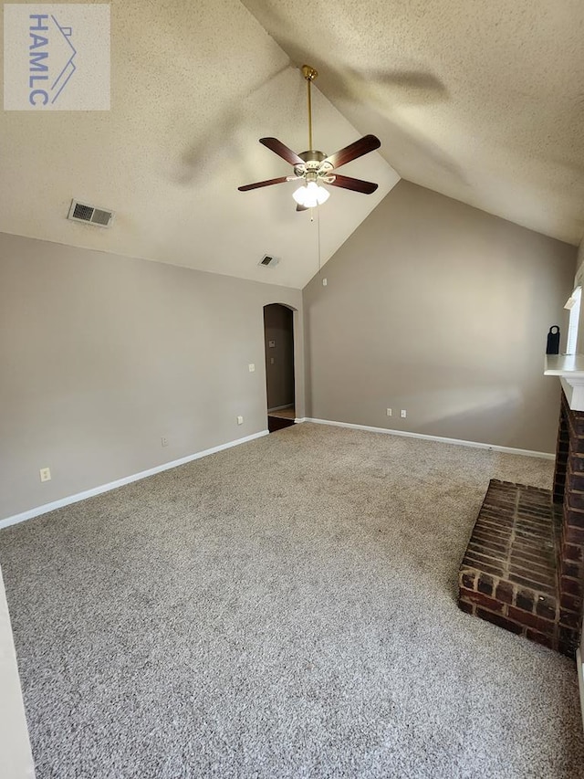 unfurnished living room with a ceiling fan, carpet, arched walkways, lofted ceiling, and baseboards