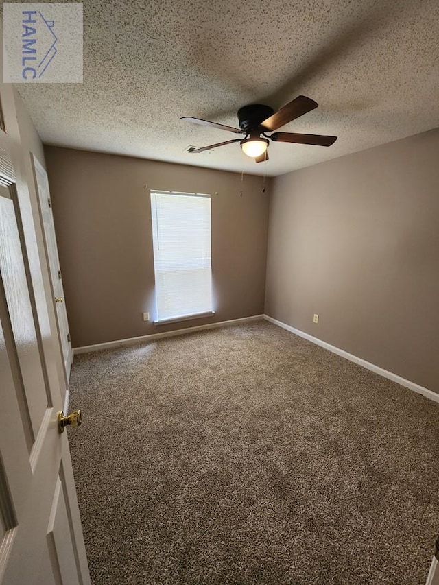spare room with ceiling fan, carpet floors, and baseboards