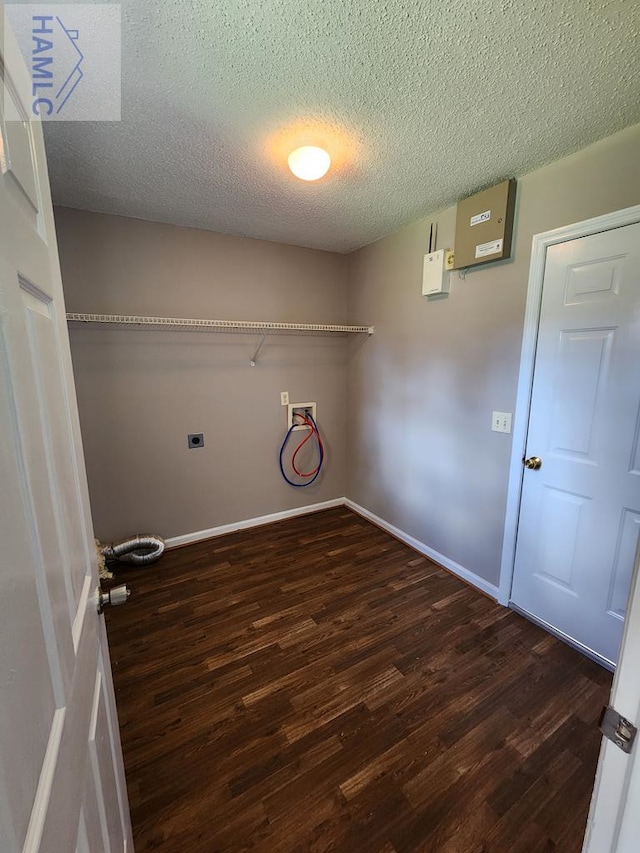 washroom featuring wood finished floors, electric dryer hookup, washer hookup, a textured ceiling, and baseboards
