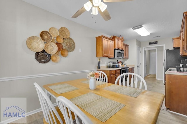 dining room featuring ceiling fan and light wood-type flooring