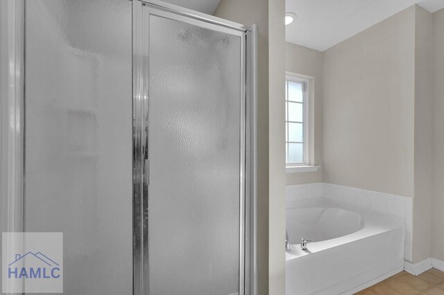 bathroom with shower with separate bathtub