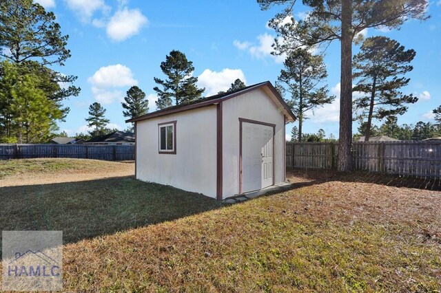 view of outbuilding with a lawn