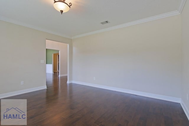 empty room with ornamental molding, dark wood-style flooring, and baseboards
