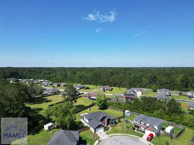 aerial view of residential area with a heavily wooded area