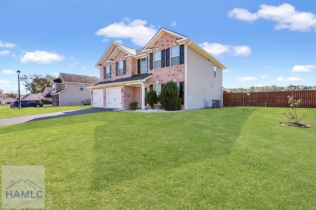 view of front of house featuring a front yard, a garage, and central AC unit