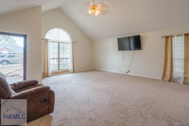 unfurnished room featuring light colored carpet, high vaulted ceiling, and ceiling fan