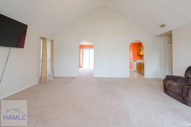 living room featuring light colored carpet and high vaulted ceiling