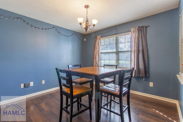 dining room with a chandelier, a textured ceiling, and dark hardwood / wood-style flooring