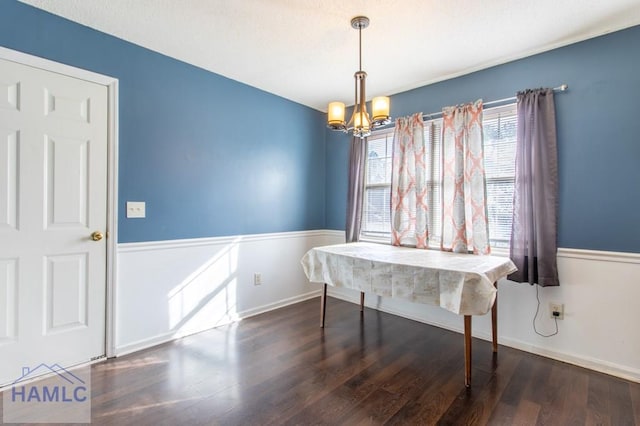 dining area featuring dark wood-type flooring and a chandelier