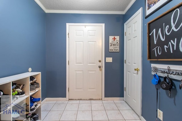 entrance foyer featuring ornamental molding, light tile patterned floors, and a textured ceiling