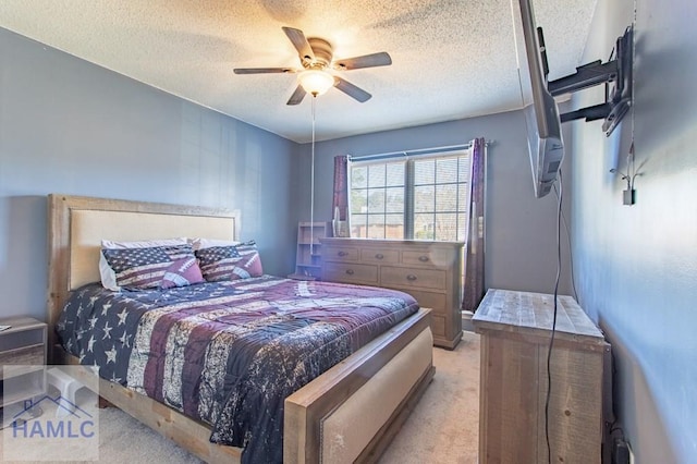 carpeted bedroom with ceiling fan and a textured ceiling