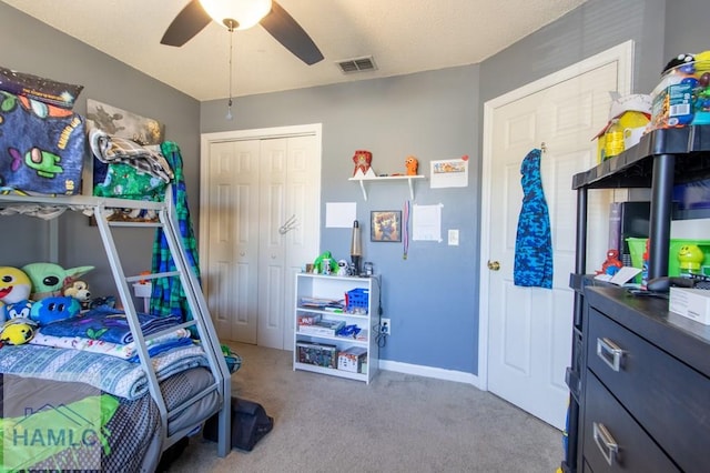 carpeted bedroom featuring a closet and ceiling fan