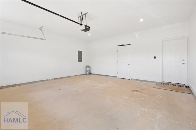 garage featuring electric panel, baseboards, and a garage door opener