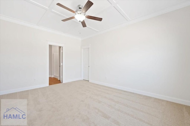 spare room with crown molding, baseboards, coffered ceiling, and light carpet