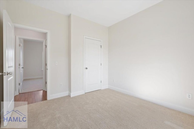 unfurnished bedroom with baseboards and carpet floors