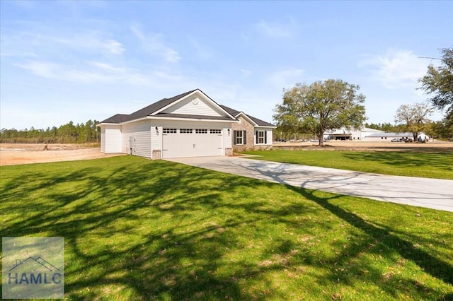 view of front of house featuring a garage, driveway, and a front lawn