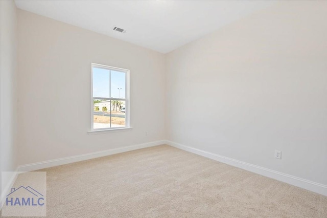 empty room featuring visible vents, baseboards, and carpet flooring