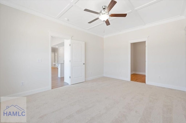 carpeted spare room with coffered ceiling, crown molding, and baseboards