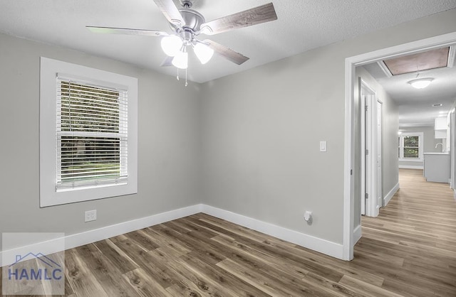 123 2nd Ave, Midway, GA 31313 - spare room with attic access, wood finished floors, and ceiling fan