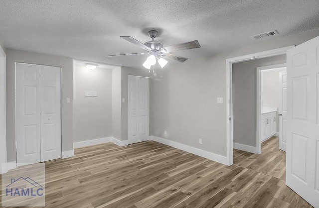 123 2nd Ave, Midway, GA 31313 - unfurnished bedroom featuring a textured ceiling, light wood-type flooring, and a ceiling fan
