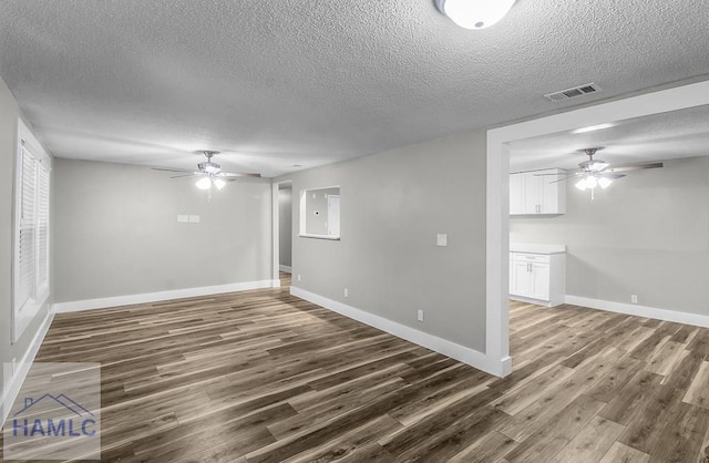 123 2nd Ave, Midway, GA 31313 - unfurnished living room with ceiling fan, a textured ceiling, and dark wood-style floors