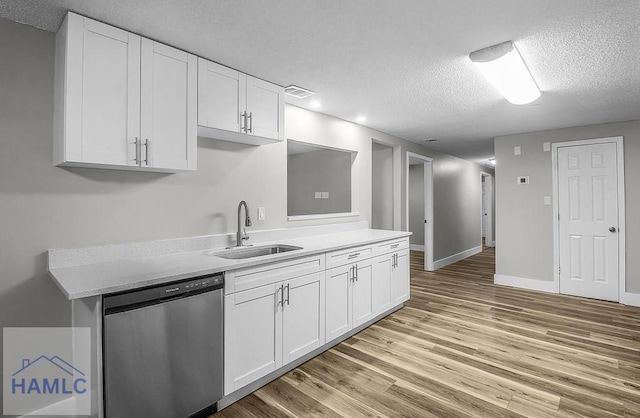 123 2nd Ave, Midway, GA 31313 - kitchen with dishwasher, a textured ceiling, light wood-style flooring, white cabinets, and recessed lighting