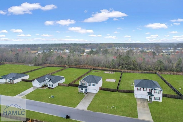 birds eye view of property featuring a view of trees and a rural view