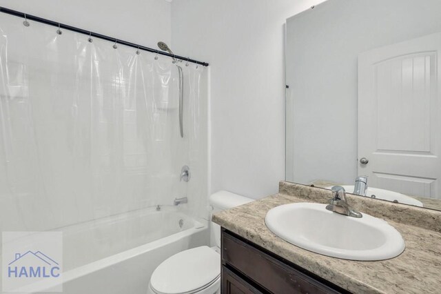 bathroom featuring vanity, toilet, and shower / tub combo