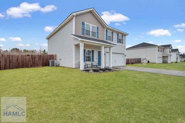 traditional-style house featuring a front lawn, an attached garage, driveway, and fence