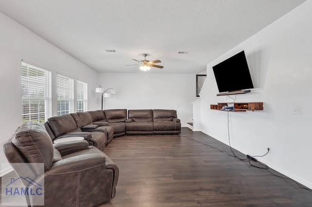 living room with wood finished floors, visible vents, and ceiling fan