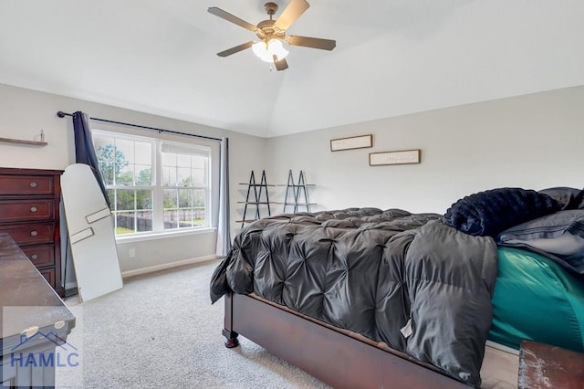 bedroom with baseboards, ceiling fan, carpet flooring, and vaulted ceiling