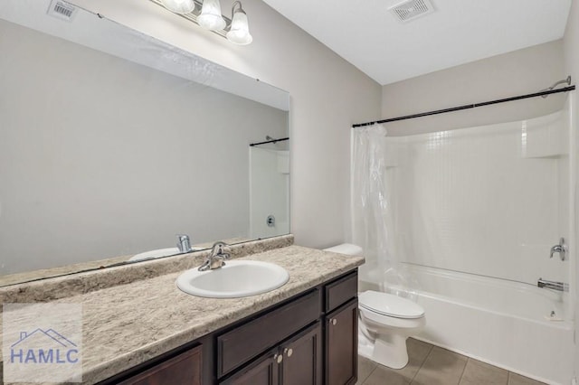 full bathroom with tile patterned flooring, toilet, visible vents, and shower / tub combo with curtain