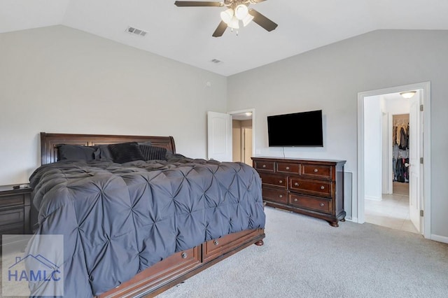 carpeted bedroom featuring visible vents, baseboards, a ceiling fan, and vaulted ceiling