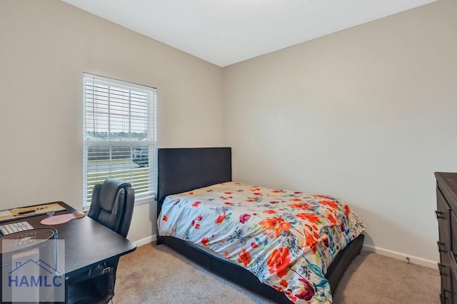 bedroom featuring carpet and baseboards