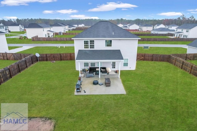 rear view of house with a yard, a residential view, a patio, and a fenced backyard