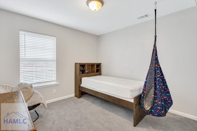 bedroom with visible vents, baseboards, and carpet