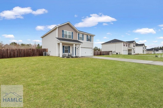 traditional home with driveway, an attached garage, a front yard, and fence