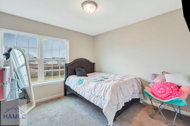 carpeted bedroom with baseboards