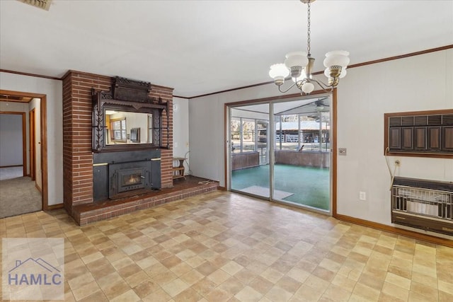 unfurnished living room featuring heating unit, a warm lit fireplace, ornamental molding, and an inviting chandelier