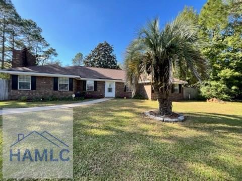 ranch-style home with a front lawn