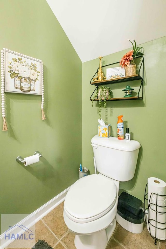 bathroom with tile patterned flooring, lofted ceiling, and toilet