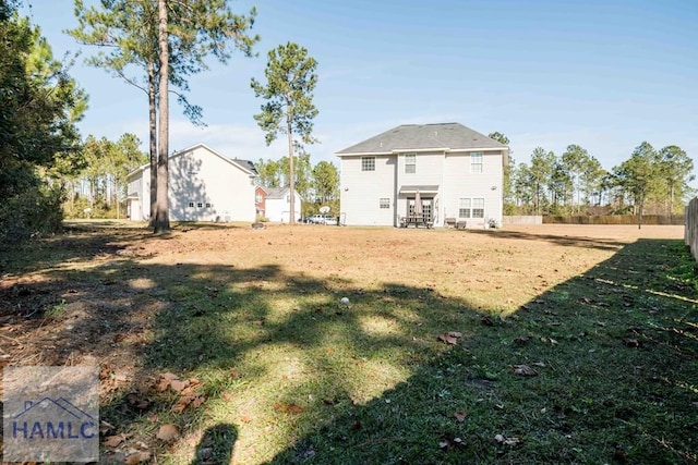 rear view of property with a yard