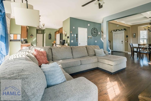 living room featuring beam ceiling, ceiling fan with notable chandelier, and dark hardwood / wood-style floors