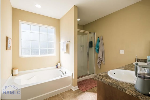 bathroom featuring vanity, plenty of natural light, and plus walk in shower