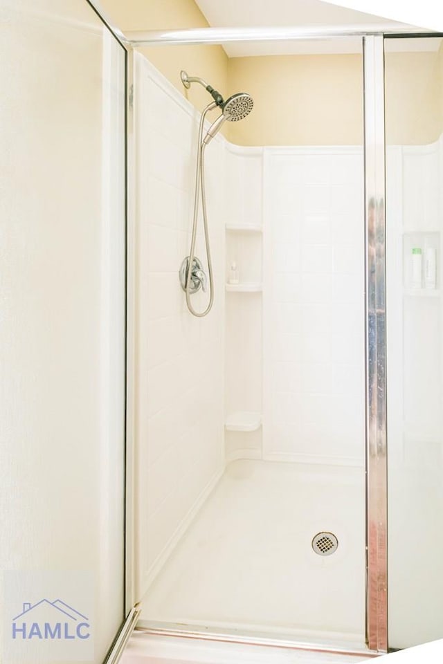 bathroom with a shower with shower door