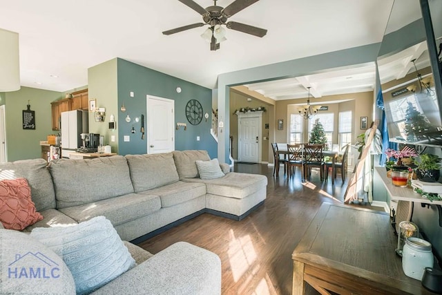 living room featuring beamed ceiling, ceiling fan with notable chandelier, dark wood-type flooring, and coffered ceiling