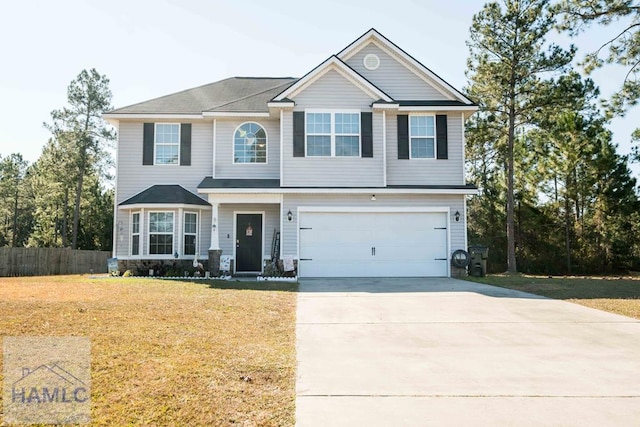 view of front of home featuring a garage and a front yard